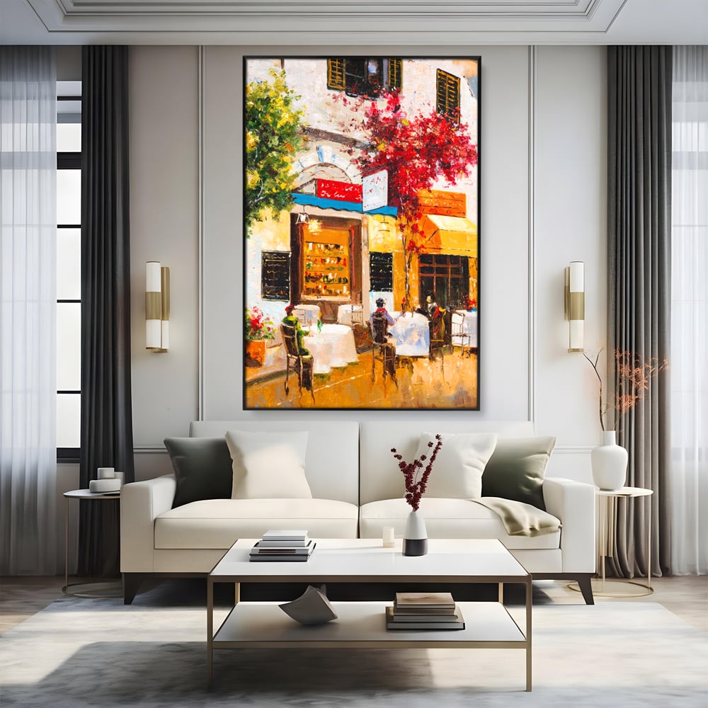 Tablou canvas cu pictura stradala cu terasa, in rama de aluminiu negru, pe perete intr-un living